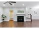 Spacious living room featuring a fireplace, hardwood floors, and an adjacent entry and staircase at 627 Balsam Fir Dr, Cary, NC 27519