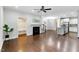 Spacious open-concept living room with fireplace, hardwood floors, kitchen, and staircase at 627 Balsam Fir Dr, Cary, NC 27519
