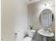 Bright powder room features pedestal sink, oval mirror, and neutral paint at 627 Balsam Fir Dr, Cary, NC 27519