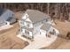 Aerial view of a home with a three-car garage, fenced yard and a well-manicured lawn at 664 The Parks Dr, Pittsboro, NC 27312