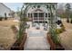 Inviting backyard with an arbor entrance leading to a patio, fire pit, and outdoor seating at 664 The Parks Dr, Pittsboro, NC 27312