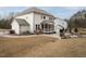 Spacious backyard featuring a stone patio, fire pit, screened porch, and home exterior at 664 The Parks Dr, Pittsboro, NC 27312