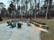 Outdoor living space with a stone patio, fire pit, and comfortable seating arrangement at 664 The Parks Dr, Pittsboro, NC 27312