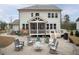 Well-maintained backyard with a stone patio, fire pit, and comfortable outdoor seating at 664 The Parks Dr, Pittsboro, NC 27312