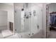Modern bathroom with glass shower, white tile, and access to the walk-in closet at 664 The Parks Dr, Pittsboro, NC 27312