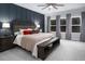 Main bedroom with accent wall, bench, ceiling fan, and multiple windows offering natural light at 664 The Parks Dr, Pittsboro, NC 27312