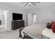 Neutral main bedroom features a ceiling fan, mounted television and ensuite bathroom at 664 The Parks Dr, Pittsboro, NC 27312