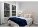 Cozy bedroom with a queen bed, plush pillows, and natural light from a large window at 664 The Parks Dr, Pittsboro, NC 27312
