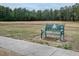 Inviting green bench in the community's common area providing a tranquil spot amidst the natural surroundings at 664 The Parks Dr, Pittsboro, NC 27312