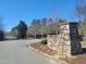 Stone monument marking the community entrance with meticulous landscaping and an iron gate for added security at 664 The Parks Dr, Pittsboro, NC 27312