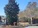 A gated entrance to the community providing exclusivity, with beautiful trees and landscaped areas at 664 The Parks Dr, Pittsboro, NC 27312