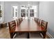 Dining room features a long, modern table with ten chairs and a view of the backyard at 664 The Parks Dr, Pittsboro, NC 27312