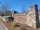 The stone entrance sign welcomes visitors with rustic charm and established neighborhood branding at 664 The Parks Dr, Pittsboro, NC 27312