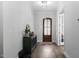 Welcoming entryway with hardwood floors, statement mirror, and elegant decor at 664 The Parks Dr, Pittsboro, NC 27312