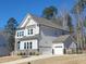 Charming home with white siding, stone accents, attached garage and well-maintained landscaping at 664 The Parks Dr, Pittsboro, NC 27312