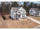A bright home featuring stone accents, a three-car garage, and a manicured front lawn at 664 The Parks Dr, Pittsboro, NC 27312