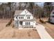 A beautiful home featuring stone accents, a three-car garage, and a manicured front lawn at 664 The Parks Dr, Pittsboro, NC 27312