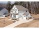 A bright home featuring a three-car garage, fenced yard and a well-manicured lawn at 664 The Parks Dr, Pittsboro, NC 27312
