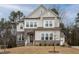 Charming two-story home featuring a stone facade, multiple windows, and a well-maintained front yard at 664 The Parks Dr, Pittsboro, NC 27312