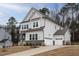 Beautiful home with stone accents, a two-car garage, and a well-maintained front lawn at 664 The Parks Dr, Pittsboro, NC 27312