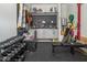 Organized garage featuring custom shelving, work bench, and workout equipment providing room for cars and hobbies at 664 The Parks Dr, Pittsboro, NC 27312
