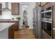 Gourmet kitchen boasts stainless steel appliances, granite countertops, and a walk-in pantry at 664 The Parks Dr, Pittsboro, NC 27312