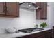 This is a shot of the kitchen with white backsplash, marble countertops and stainless steel oven hood at 664 The Parks Dr, Pittsboro, NC 27312