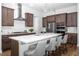 Eat-in kitchen features stainless steel appliances, modern cabinets, white subway tile backsplash, and a large island at 664 The Parks Dr, Pittsboro, NC 27312