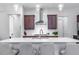 Spacious kitchen with a large island, white countertops, modern lighting, and stainless steel range at 664 The Parks Dr, Pittsboro, NC 27312