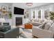 Cozy living room boasts a gas fireplace, floating shelves, recessed lighting, and several large windows at 664 The Parks Dr, Pittsboro, NC 27312