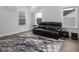 This is an upstairs living room with laminate floor, grey and white walls, and natural light at 664 The Parks Dr, Pittsboro, NC 27312