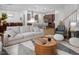 Open-concept living room has natural lighting, recessed lights, a decorative chandelier, and hardwood floors at 664 The Parks Dr, Pittsboro, NC 27312