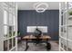 Home office with a modern desk, decorative lighting, and french doors for privacy at 664 The Parks Dr, Pittsboro, NC 27312