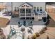 A spacious backyard patio featuring a fire pit, screened-in porch, and an array of comfortable outdoor seating at 664 The Parks Dr, Pittsboro, NC 27312
