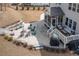 A well-appointed patio with outdoor seating, a fire pit, and a screened-in porch for relaxing and entertaining at 664 The Parks Dr, Pittsboro, NC 27312