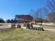The open-air pergola offers a shaded area for relaxation and social gatherings on the green lawn at 664 The Parks Dr, Pittsboro, NC 27312