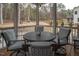 A cozy screened porch featuring a round table, chairs, and a decorative lantern, perfect for relaxation at 664 The Parks Dr, Pittsboro, NC 27312