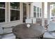 A cozy screened porch with a table and chairs, perfect for enjoying the outdoors and a morning coffee at 664 The Parks Dr, Pittsboro, NC 27312