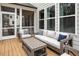 Relaxing screened porch with comfortable outdoor seating and a wood coffee table at 664 The Parks Dr, Pittsboro, NC 27312