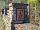 The stone wall with an emblem detail serves as a decorative addition to the property's landscape at 664 The Parks Dr, Pittsboro, NC 27312