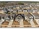 Neighborhood aerial showcasing solar panels on home roofs amidst residential streets and community at 721 Sage Oak Ln, Holly Springs, NC 27540