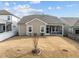 The backyard features a simple, grassy yard and a screened in patio area at 721 Sage Oak Ln, Holly Springs, NC 27540