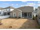 Exterior backyard view with a screened-in porch and well-maintained lawn at 721 Sage Oak Ln, Holly Springs, NC 27540