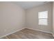 Bedroom featuring wood flooring, a window, and base molding at 721 Sage Oak Ln, Holly Springs, NC 27540