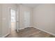 Bedroom with wood flooring and an open door to the rest of the house at 721 Sage Oak Ln, Holly Springs, NC 27540