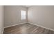 Bedroom featuring wood flooring, a window, and base molding at 721 Sage Oak Ln, Holly Springs, NC 27540