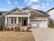 Beautiful home featuring stone accents, solar panels, and a two-car garage at 721 Sage Oak Ln, Holly Springs, NC 27540