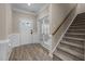 The bright foyer features wood flooring, staircase, and glass paneled doors at 721 Sage Oak Ln, Holly Springs, NC 27540