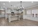 Open floor plan featuring a modern kitchen with an island, pendant lighting, and a dining nook at 721 Sage Oak Ln, Holly Springs, NC 27540