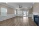 Bright and airy living room featuring a cozy fireplace, large windows, and a ceiling fan at 721 Sage Oak Ln, Holly Springs, NC 27540